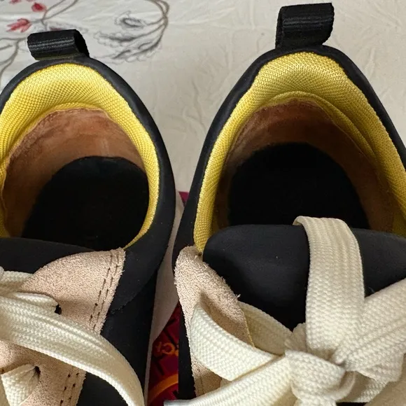 Tory Burch. Good luck trainers.Stylish Black and Tan Women's Sneakers.