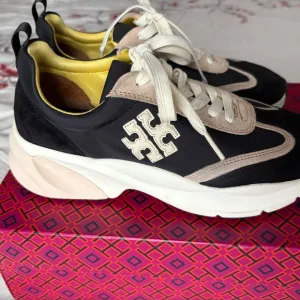 Tory Burch. Good luck trainers.Stylish Black and Tan Women's Sneakers.